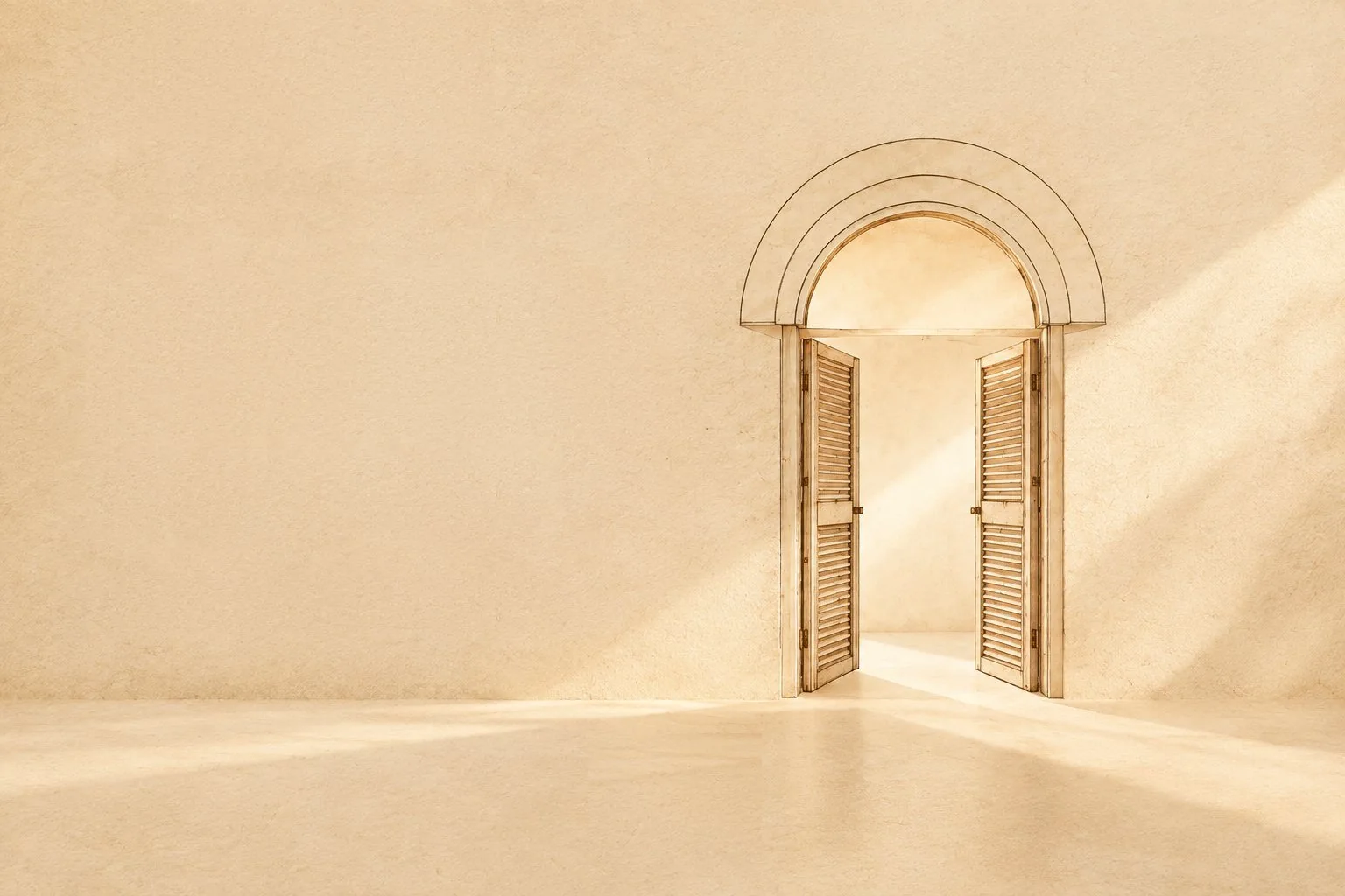 A sunlit plastered room with an open arched doorway